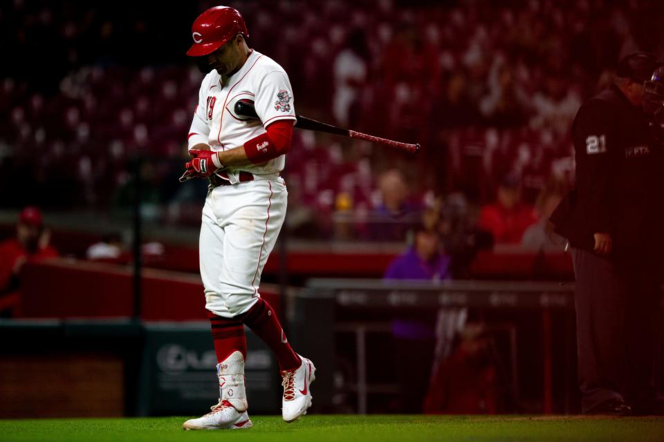 Cincinnati Reds first baseman Joey Votto (19) walks back to the dugout after striking out.