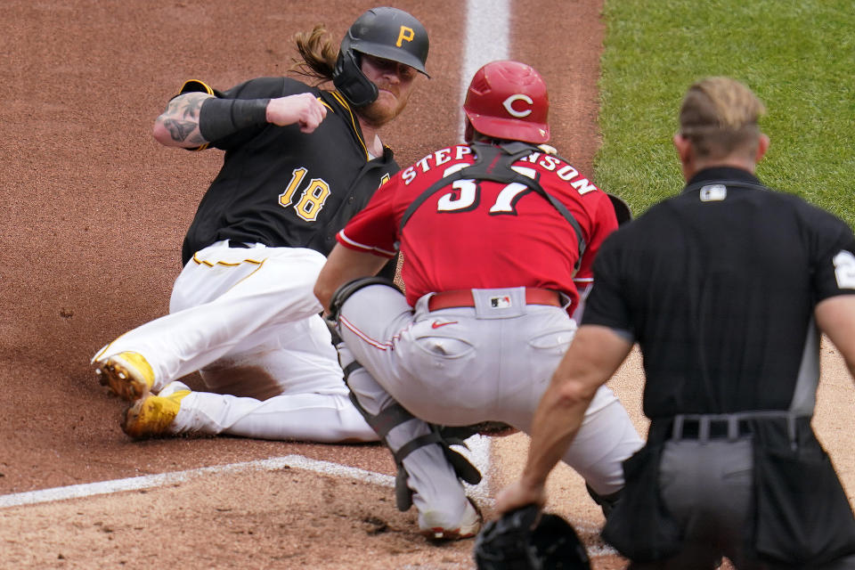 Cincinnati Reds catcher Tyler Stephenson (37) prepares to tag out Pittsburgh Pirates' Ben Gamel (18) who was attempting to score from third on a fielder's choice by Michael Perez during the second inning of a baseball game in Pittsburgh, Thursday, Sept. 16, 2021. (AP Photo/Gene J. Puskar)