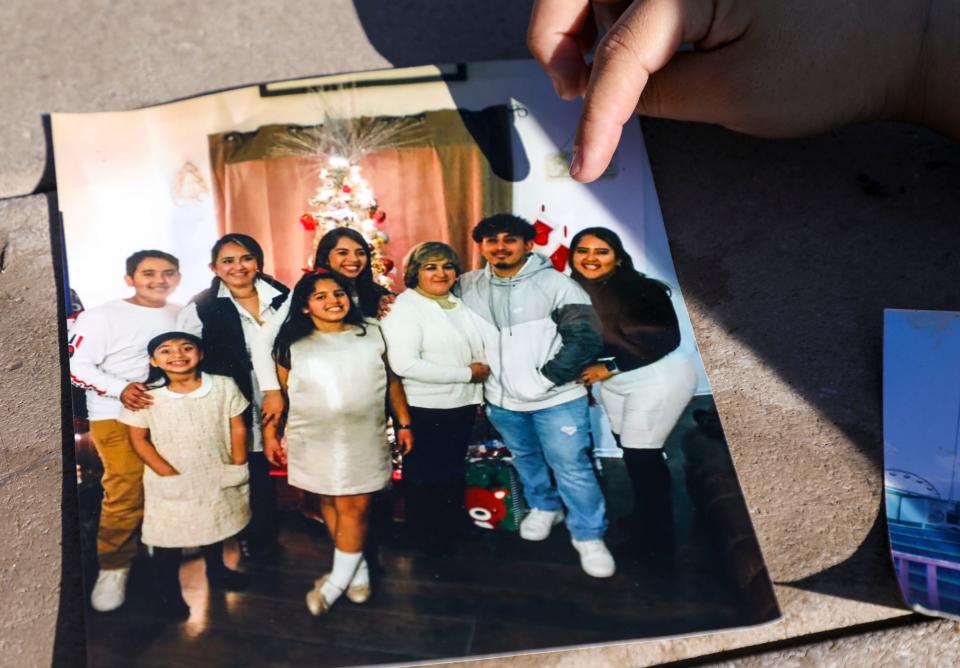 Liz Hernandez points to her brother, Luis, in a family photo taken at Christmas 2019.