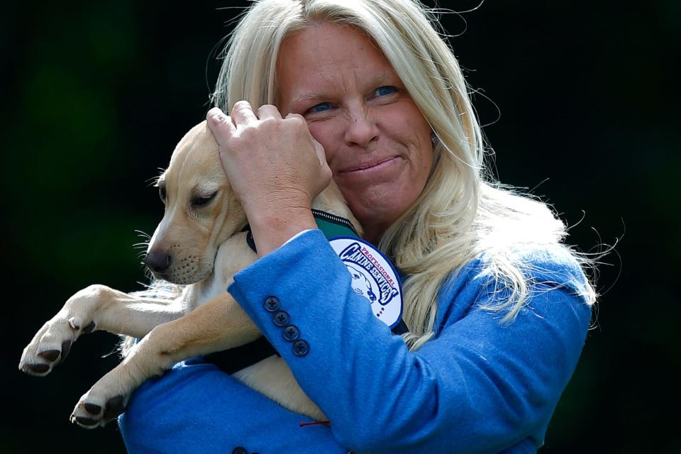 Jill Fearons, president of Friends of Jack, holds Hero during a press conference  announcing two comfort dog donations by the Friends of Jack Foundation to the Bristol County House of Correction in Dartmouth.