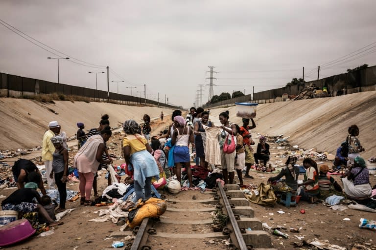 Hawkers sell their goods at an improvised market in Luanda. Out of control public borrowing, a currency in free-fall, soaring inflation and mass unemployment are among the reasons that at least two million Angolans live on less than $2 a day