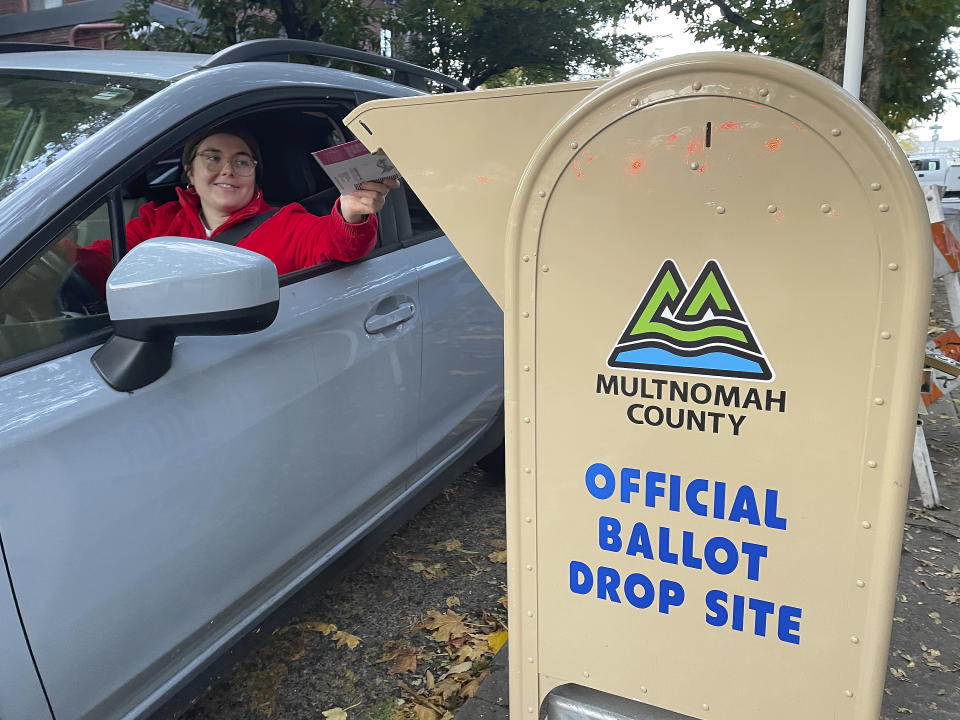 FILE - A voter drops off a ballot in a drop box in Portland, Ore., on Election Day, Tuesday, Nov. 8, 2022. Oregon is losing its second elections director in as many years, with the current one announcing her resignation, saying the job is extremely challenging and complaining of uncertain funding. (AP Photo/Claire Rush, File)