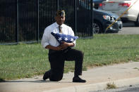 <p>SEPT. 27, 2017 – U.S. Army veteran Marvin Boatright kneels with a folded U.S. flag as the motorcade of President Donald Trump passes him after an event at the state fairgrounds in Indianapolis, Indiana. This was soon after President Donald Trump had made comments condemning NFL players who kneel during the national anthem. Boatwright said that he wanted to send a message against social injustice. (Photo: Jonathan Ernst/Reuters) </p>