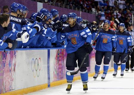 Finland's Juhamatti Aaltonen (50) celebrates his goal against Russia with teammates during the first period of their men's quarter-finals ice hockey game at the Sochi 2014 Winter Olympic Games February 19, 2014. REUTERS/Mark Blinch