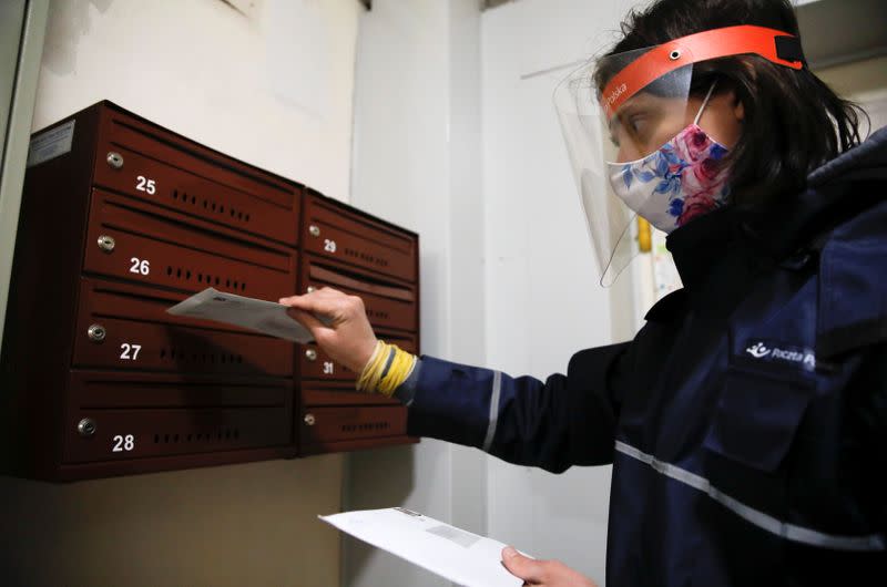 Postman delivers the letters to a mailbox in Warsaw