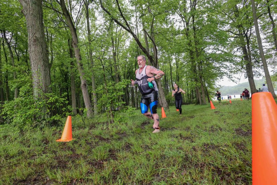 A runner tackles the trails barefoot in the Bear Triathlon on May 15 at Lums Pond State Park.