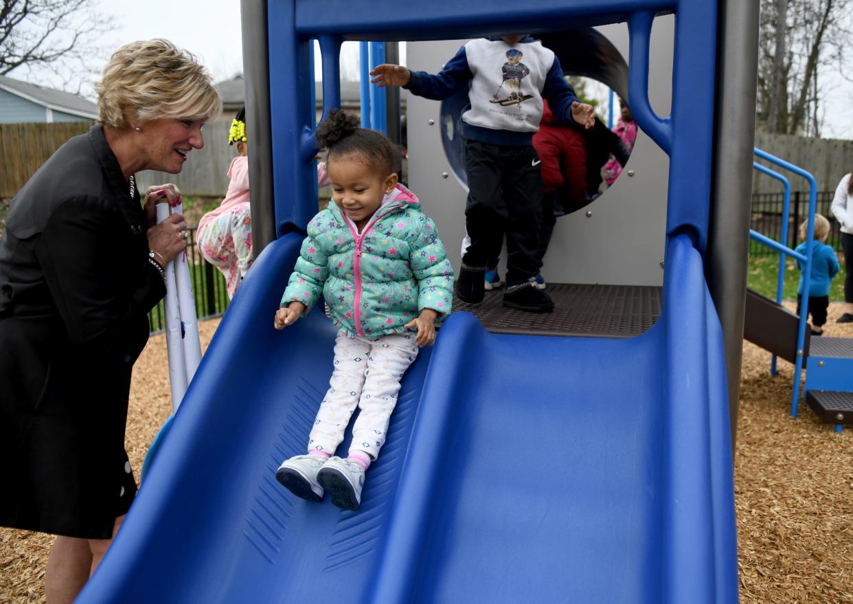 Huntington Bank Community Greater Canton President Sandy K. Upperman celebrates with DaiS Ware, 3, as JRC Learning Center dedicates new playground equipment at the JRC Myrna Pastore Campus.
