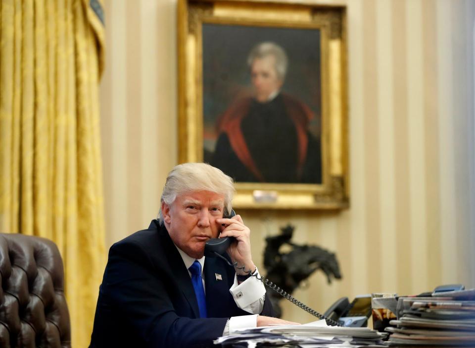 FILE - In this Saturday, Jan. 28, 2017 file photo, President Donald Trump speaks on the telephone with Australian Prime Minister Malcolm Turnbull in the Oval Office of the White House in Washington. In the background is a portrait of former President Andrew Jackson which Trump had installed in the first few days of his administration. President Donald Trump may have raised eyebrows over a series of racist tweets in July 2019 but it's not the first time a U.S. president has sparked attention for racist gestures. (AP Photo/Alex Brandon, File)