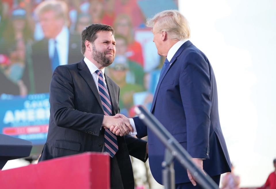 J.D. Vance shakes hands with former President Donald Trump during a rally at the Delaware County Fairgrounds on April 23, 2022.