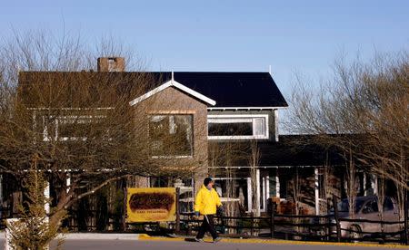 A man walks by the Los Sauces hotel, owned by former Argentina's President Cristina Fernandez de Kirchner, in El Calafate, Argentina, October 16, 2009. REUTERS/Marcos Brindicci/File Photo