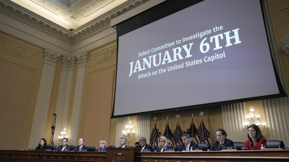 Members of the House panel seated under a screen saying Select Committee to investigate the JANUARY 6TH Attack on the United States Capitol,