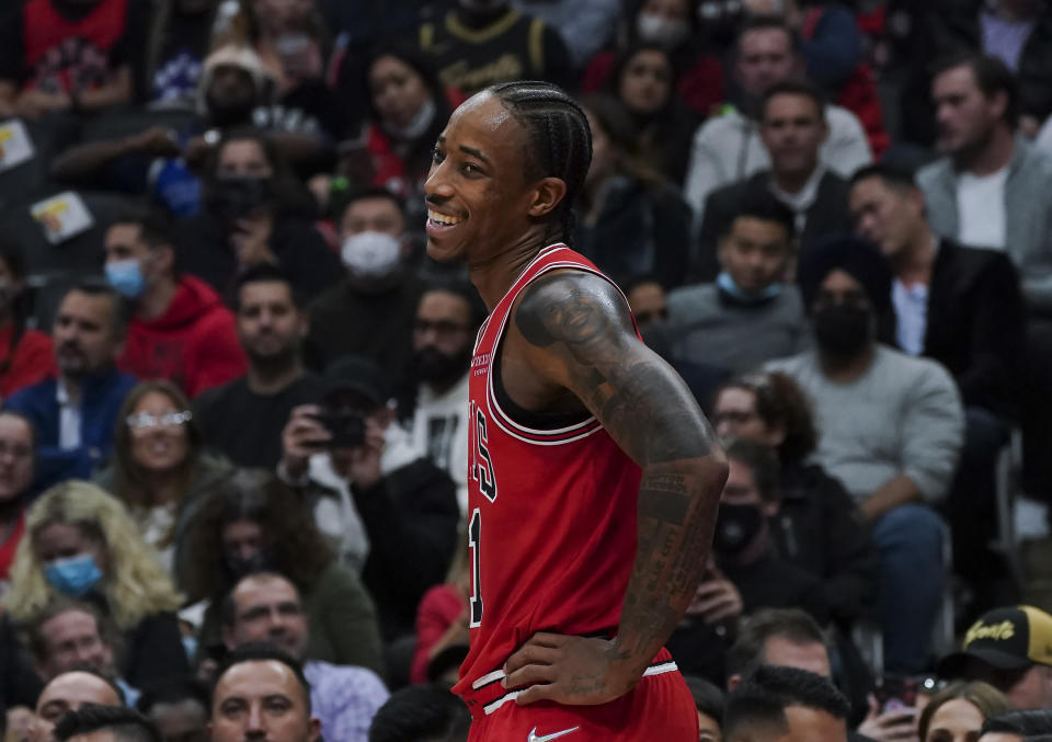 Chicago Bulls forward DeMar DeRozan (11) smiles on the court during first-half NBA basketball game action against the Toronto Raptors in Toronto, Monday, Oct. 25, 2021. (Nathan Denette/The Canadian Press via AP)