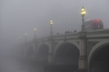Workers cross Westminster Bridge on a misty morning in London, Britain, November 2, 2015. REUTERS/Toby Melville