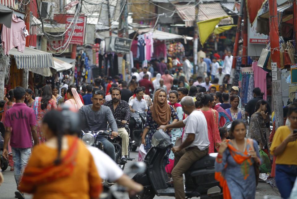 People throng a market on the eve of Eid al Adha, in Jammu, India, Sunday, Aug.11, 2019. Authorities in Indian-administered Kashmir said that they eased restrictions Sunday in most parts of Srinagar, the main city, ahead of an Islamic festival following India's decision to strip the region of its constitutional autonomy. There was no immediate independent confirmation of reports by authorities that people were visiting shopping areas for festival purchases as all communications and the internet remain cut off for a seventh day. (AP Photo/Channi Anand)