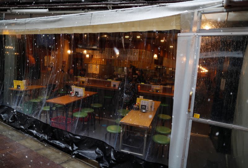 Empty seats are seen inside a restaurant in a snow fall during a coronavirus disease outbreak in Tokyo