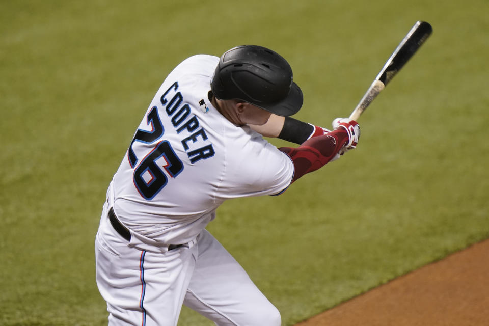 Miami Marlins' Garrett Cooper (26) hits a two-run home run during the first inning of a baseball game against the Boston Red Sox, Wednesday, Sept. 16, 2020, in Miami. (AP Photo/Lynne Sladky)