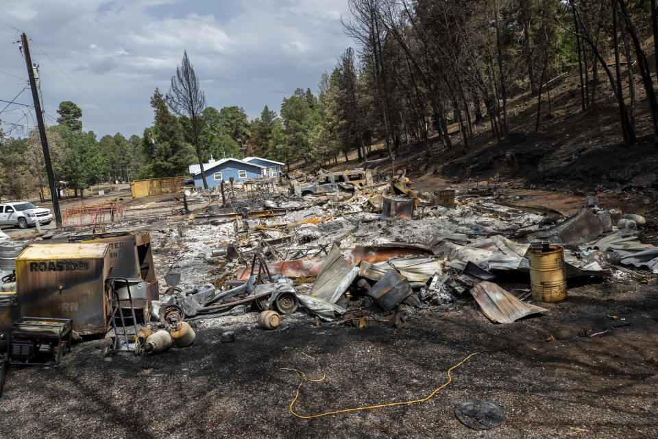 A flattened house that was destroyed by the South Fork Fire is shown in the mountain village of Ruidoso, N.M., Saturday, June 22, 2024. Recent rains and cooler weather are helping more than 1,000 firefighters gain ground on two wildfires in southern New Mexico that have killed two people, destroyed hundreds of homes and forced thousands to flee. (AP Photo/Andres Leighton)