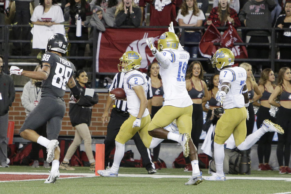 UCLA wide receiver Kyle Philips (2) returns a punt for a touchdown in front of teammates Alex Johnson (19), Mo Osling III (7) and Washington State wide receiver Rodrick Fisher (88) during the second half of an NCAA college football game in Pullman, Wash., Saturday, Sept. 21, 2019. UCLA won 67-63. (AP Photo/Young Kwak)