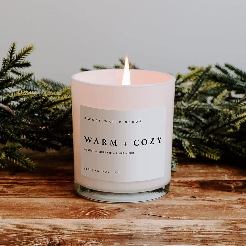 <p>Get into the holiday spirit with a <span>Sweet Water Decor Warm and Cozy Soy Candle</span> ($24). It has notes of pine, orange, cinnamon, and fir. </p>