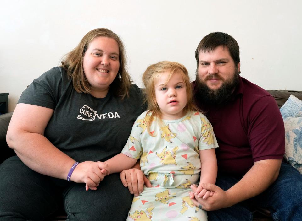 Veda Ulrich, age 4, stops for a photo with her mom and dad, Christin and Jericho Ulrich, in the family's Palm Coast home. The family found the diagnosis for their daughter's rare disease, Sanfilippo Syndrome, through a TikTok video.