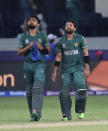 Pakistan's cricket captain Babar Azam, left, and Mohammad Rizwan celebrate after their team won the Cricket Twenty20 World Cup match between India and Pakistan in Dubai, UAE, Sunday, Oct. 24, 2021. (AP Photo/Aijaz Rahi)