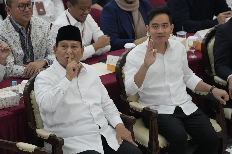 Indonesian Defense Minister and president-elect Prabowo Subianto, left, and his running mate Gibran Rakabuming Raka, the eldest son of Indonesian President JokoWidodo, gesture towards media members during their formal declaration as president and vice president-elect at the General Election Commission building in Jakarta, Indonesia, Wednesday, April 24, 2024. Indonesia’s electoral commission formally declared Subianto as the elected president in a ceremony on Wednesday after the country’s highest court rejected appeals lodged by two losing presidential candidates who are challenging his landslide victory. (AP Photo/Dita Alangkara)