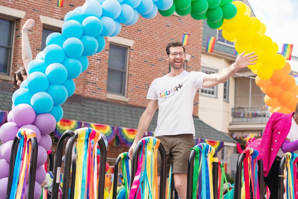 Billy stands on a Pride float in the movie