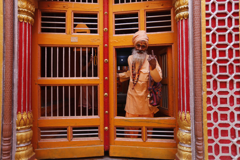 A Hindu holy man displays the indelible ink mark on his finger after casting his vote in Varanasi, India,Sunday, May 19, 2019. Indians are voting in the seventh and final phase of national elections, wrapping up a 6-week-long long, grueling campaign season with Prime Minister Narendra Modi's Hindu nationalist party seeking reelection for another five years. Counting of votes is scheduled for May 23. (AP Photo/Rajesh Kumar Singh)