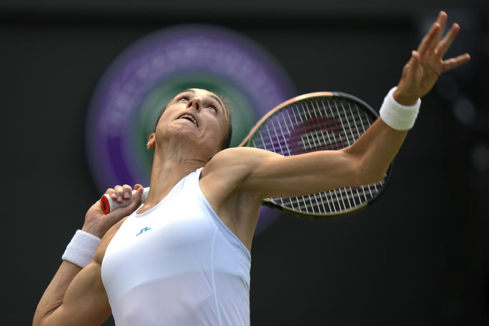 Croatia's Petra Martic serves to Kazakhstan's Elena Rybakina in a women's singles fourth round match on day eight of the Wimbledon tennis championships in London, Monday, July 4, 2022. (AP Photo/Alastair Grant)