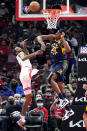 Indiana Pacers center Myles Turner, right, blocks a shot by Chicago Bulls forward Derrick Jones Jr. during the first half of an NBA basketball game in Chicago, Monday, Nov. 22, 2021. (AP Photo/Nam Y. Huh)
