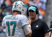 Sep 23, 2018; Miami Gardens, FL, USA; Miami Dolphins quarterback Ryan Tannehill (left) listens to head coach Adam Gase (right) during the first half against the Oakland Raiders at Hard Rock Stadium. Mandatory Credit: Steve Mitchell-USA TODAY Sports