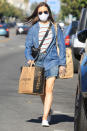 <p>Lily Collins stocks up on groceries in a chambray shirt and denim mini skirt on Wednesday in L.A. </p>