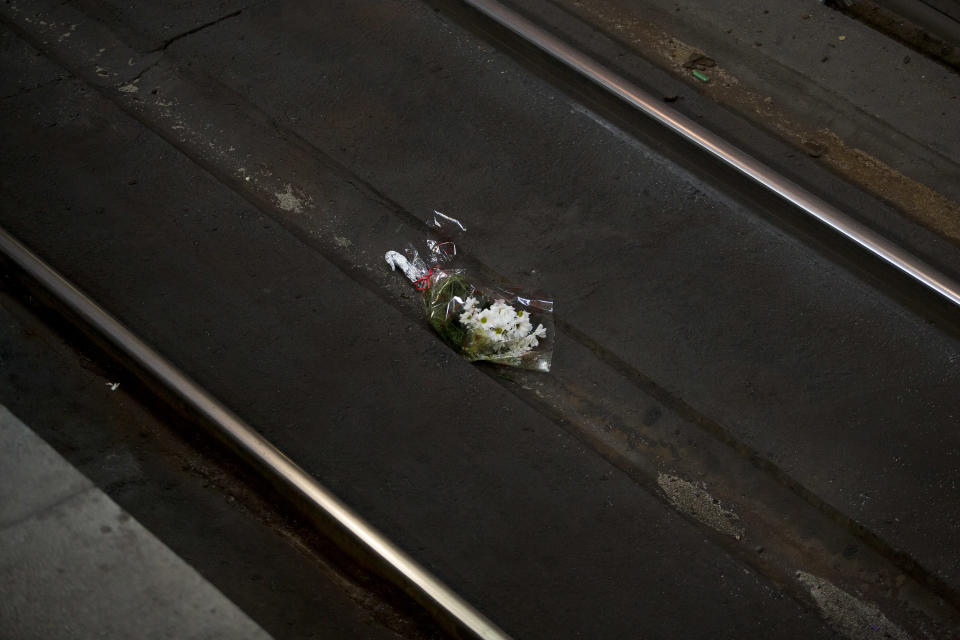 A bouquet lies on the Atocha train station railway track in Madrid, Spain, Tuesday, March 11, 2014, during the remembrance of those killed and injured in the Madrid train bombings, marking the 10th anniversary of Europe's worst Islamic terror attack. The attackers targeted four commuter trains with 10 shrapnel-filled bombs concealed in backpacks during morning rush hour on March 11, 2004. (AP Photo/Andres Kudacki)