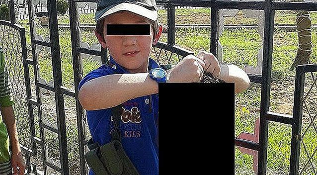 The son of a terrorist was photographed holding a severed head.Source: Twitter