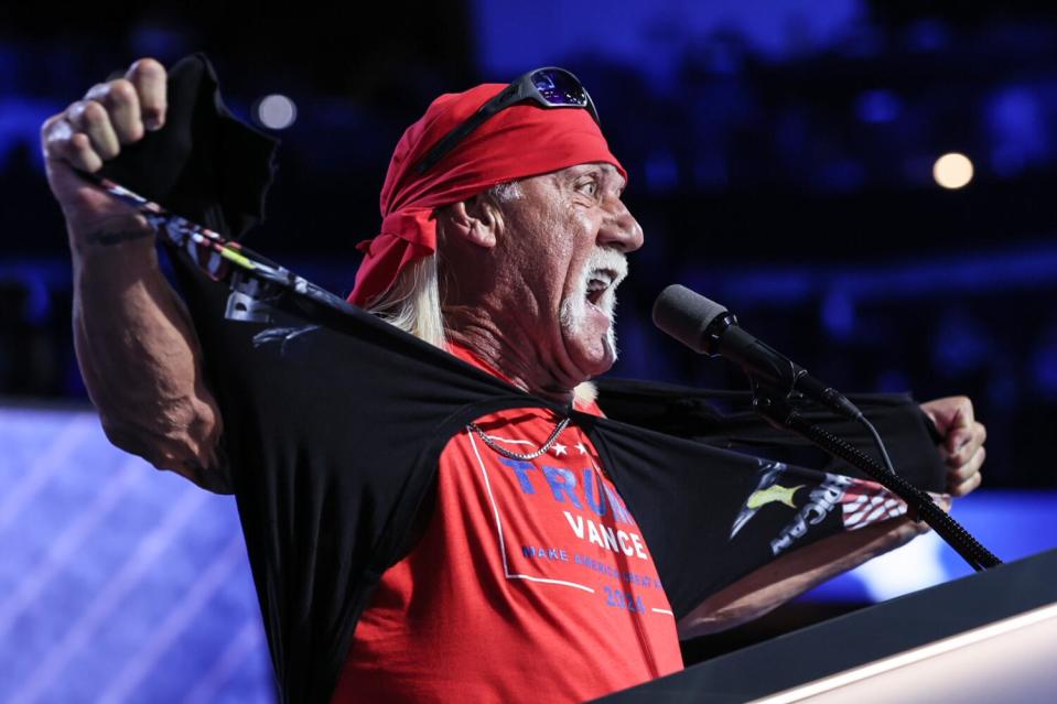 Hulk Hogan ripping off a shirt to reveal a red Trump T-shirt underneath.