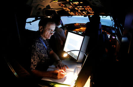 A senior instructor writes in a report book as he supervises the aviation students of Lion Air Group during a Jet Introduction session in Boeing 737-900ER simulator at Angkasa Training Center near Jakarta, Indonesia, November 2, 2018. REUTERS/Willy Kurniawan