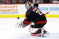 Carolina Hurricanes goaltender Antti Raanta (32) gathers in the puck during the first period of an NHL hockey game against the Calgary Flames in Raleigh, N.C., Saturday, Nov. 26, 2022. (AP Photo/Karl B DeBlaker)