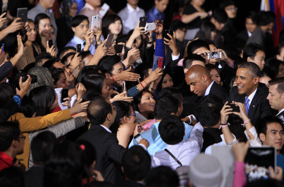 U.S. President Barack Obama, right, greets attendees after speaking at a town hall style event at the University of Malaya with participants in the Young Southeast Asian Leaders Initiative in Kuala Lumpur, Malaysia, Sunday, April 27, 2014. With the first visit to Malaysia by a U.S. president in nearly half a century, Obama holds economic and security talks with Malaysian Prime Minister Najib Razak, who leads a southeast Asian nation with an important role in Obama's efforts to forge deeper ties with the region. (AP Photo/Lai Seng Sin)