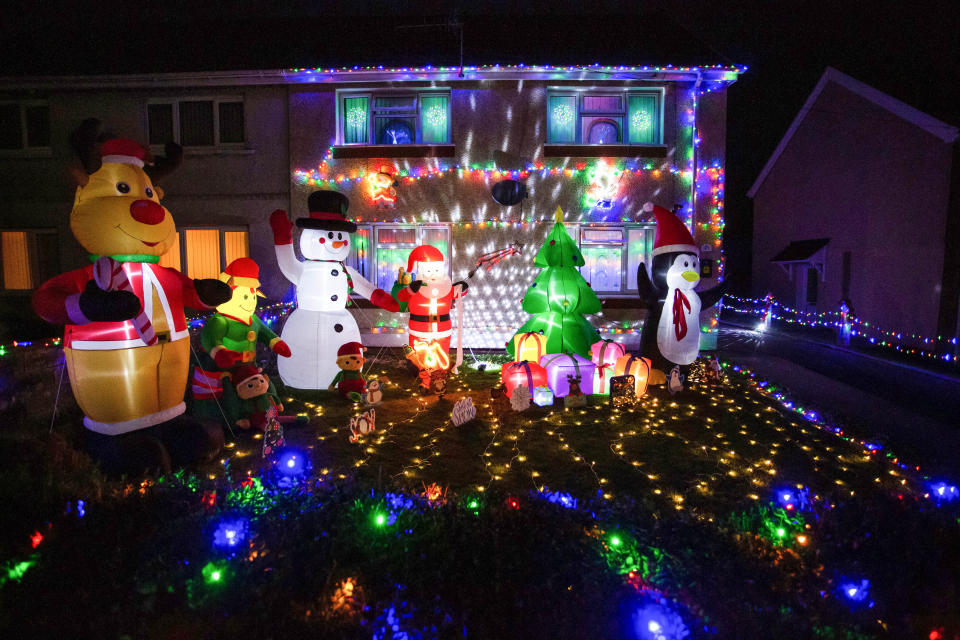A mum has gone all out to cheer up her kids and neighbours by putting up her CHRISTMAS decorations three months early - including 3,000 outdoor lights. Caroline Gabe, 46, has been shielding with her children since March - and said putting up her tree and decorations in September was a much-needed boost. She has spent the year buying outdoor lights and installations - from as far away as America - and put them all up last week, on a whim. Almost all of them are outside - including 3,000 fairy lights, sparkling snow, an 8ft inflatable snowman, as well as Santa and his reindeer.
