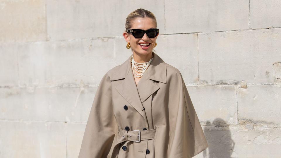 Woman wearing pearl necklace with trench coat 