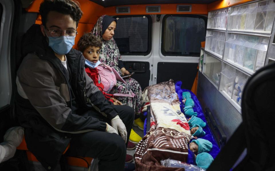 Premature Palestinian babies evacuated from Gaza City's Al Shifa hospital, are transported in a Palestinian Red Crescent ambulance through the Rafah crossing in the southern Gaza Strip to Egypt