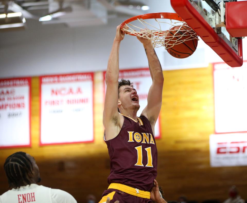 Iona's Quinn Slazinski dunks on Marist's Victor Enoh during Wednesday's game in Poughkeepsie.