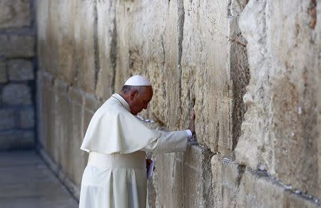 Pope Francis touches the stones of the Western Wall, Judaism's holiest prayer site, in Jerusalem's Old City May 26, 2014. REUTERS/Ronen Zvulun