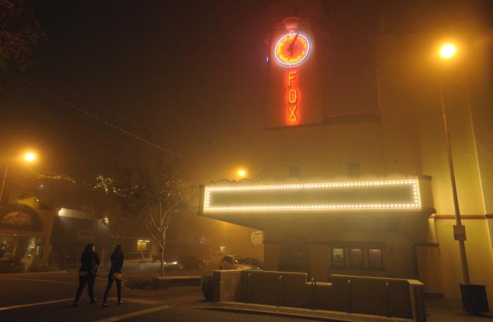The Visalia Fox Theatre glows in the fog in downtown Visalia.