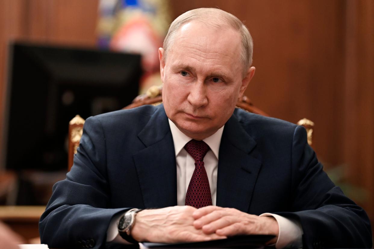 Russian President Vladimir Putin listens to Russian Prime Minister Mikhail Mishustin during their meeting at the Kremlin, 4 July (AP)