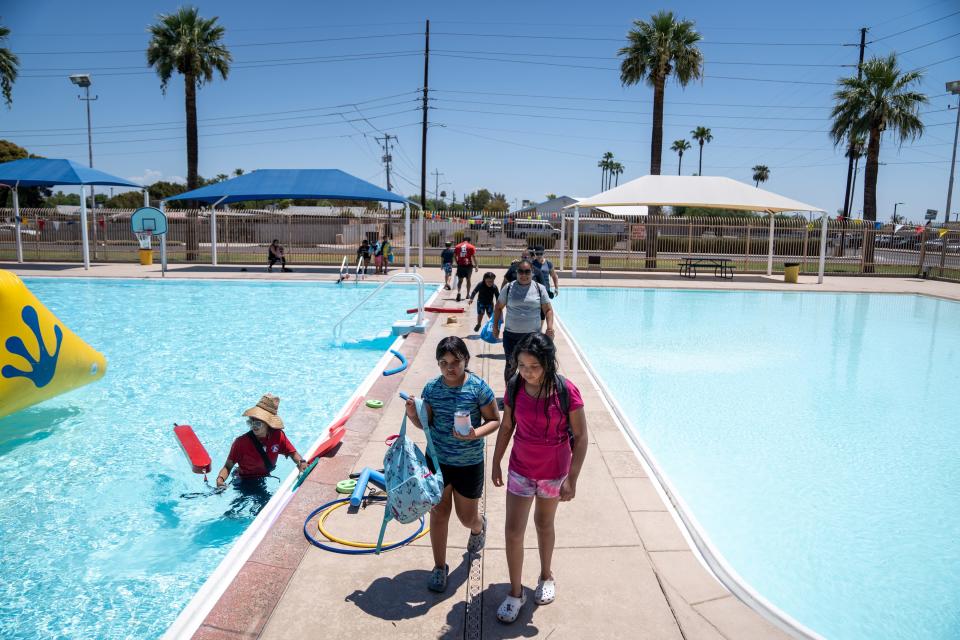 Kimberly Hernandez, 10 (left), and Delany Arizmendi (right), walk at the Falcon Pool in Phoenix on July 25, 2023.