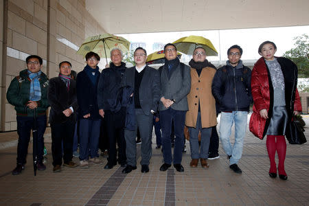 FILE PHOTO: (L-R) Pro-democracy activists Raphael Wong, Lee Wing-tat, Cheung Sau-yin, Chu Yiu-ming, Benny Tai, Chan Kin-man, Shiu Ka-chun, Chung Yiu-wa and Tanya Chan pose outside a court after a pre-trial hearing in Hong Kong, China January 9, 2018. REUTERS/Bobby Yip/File Photo