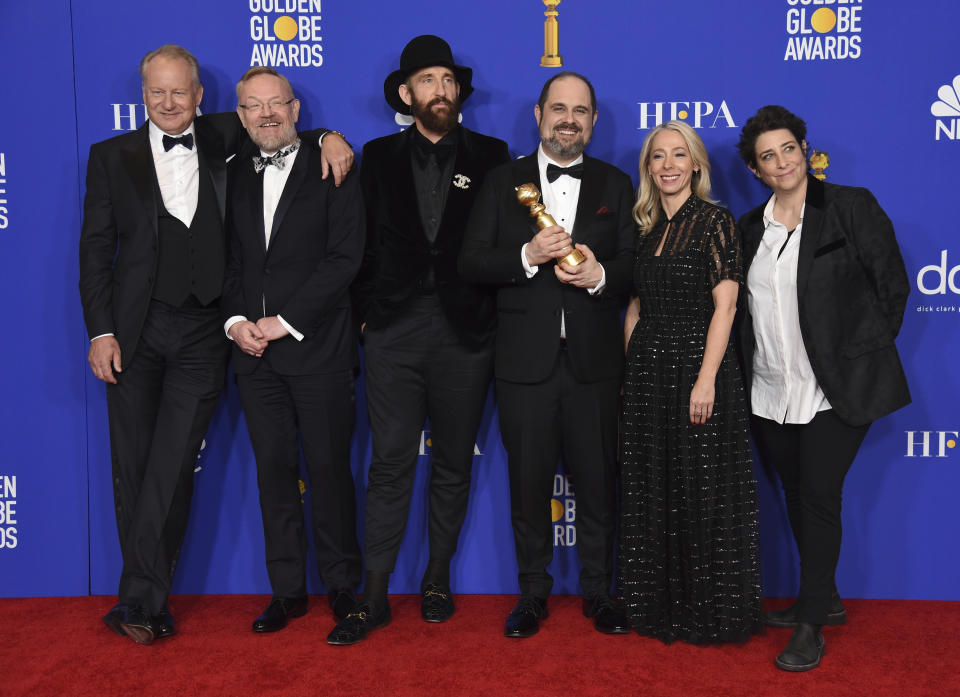 The cast and crew of &quot;Chernobyl&quot; pose in the press room with the award for best television limited series or motion picture made for television at the 77th annual Golden Globe Awards at the Beverly Hilton Hotel on Sunday, Jan. 5, 2020, in Beverly Hills, Calif. (AP Photo/Chris Pizzello)