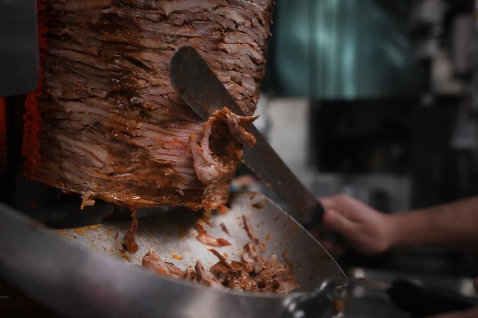 Meat is carved for the pastor burrito at Taqueria El Fundador.
