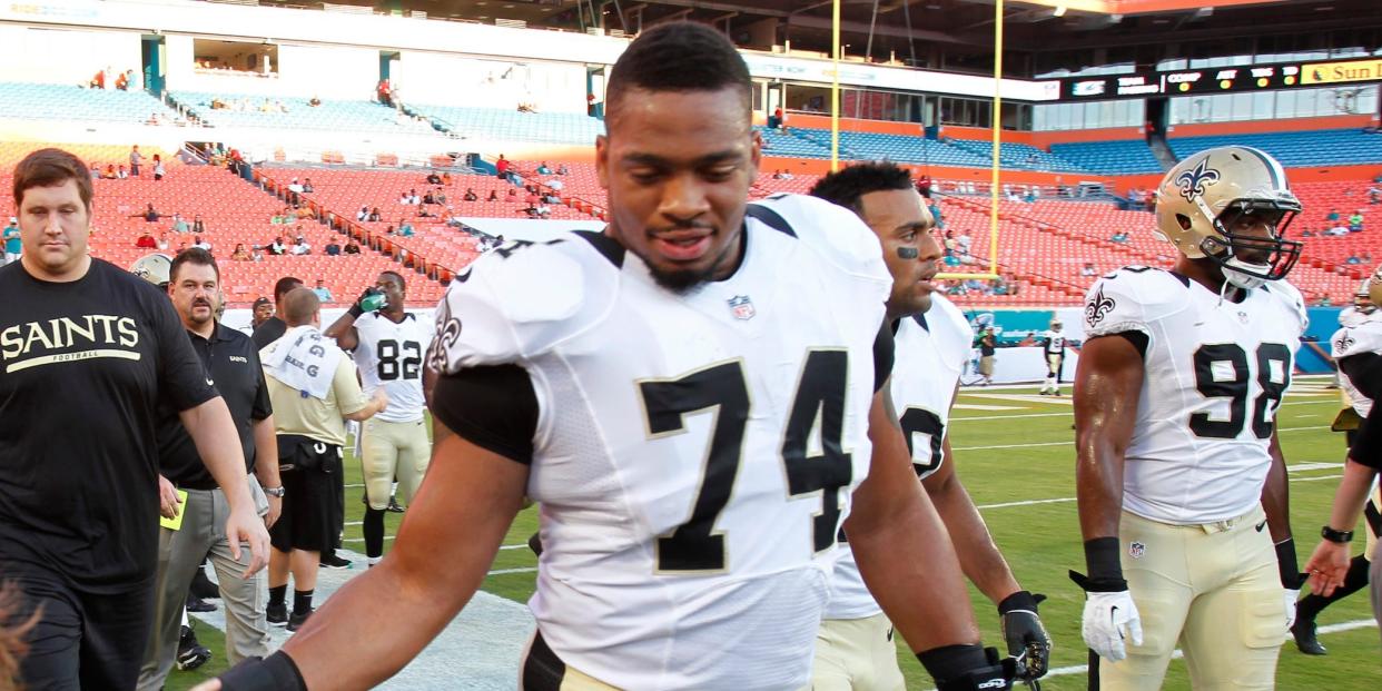 New Orleans Saints defensive end Glenn Foster (74) greets fans after practice before an NFL preseason football game against the Miami Dolphins, Thursday, Aug. 29, 2013 in Miami Gardens, Fla.